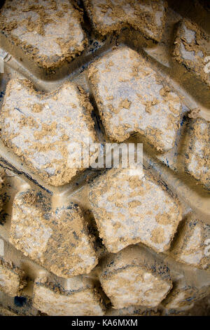 Close up of the deep tread on the tyre of an industrial digger Stock Photo