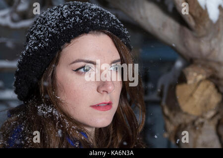 Beautiful winter portrait of young woman in the winter snowy scenery. Soft focus Stock Photo