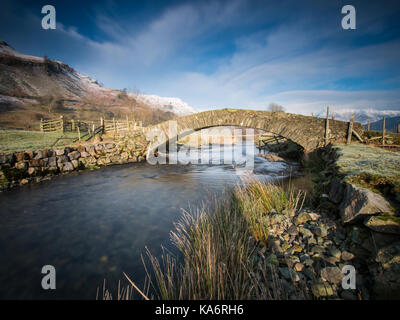 Sosgill Bridge in St John's in the Vale.  It isn't a particularly ancient bridge by Lakes Packhorse Bridge standards dating from the early 19th Centua Stock Photo