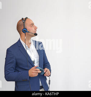 Man in Blue Suit With Voice Technology Computing Device Stock Photo