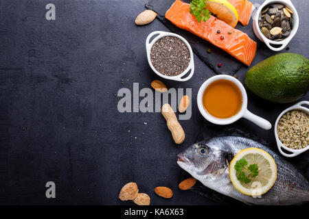 Black table with ingredients of food rich in vitamin D and omega 3, with copy space. Stock Photo