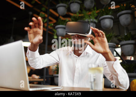 African man in glasses of virtual reality pointing in air. Stock Photo