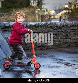 On his scooter Stock Photo