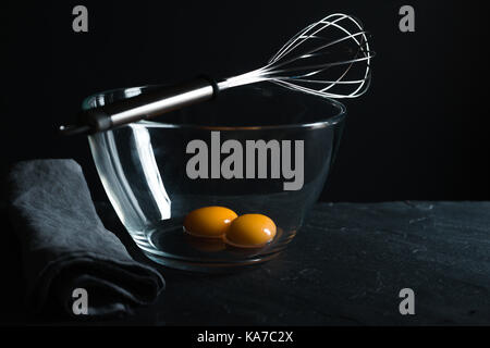 Chicken yolks in a glass bowl and whisk for whipping horizontal Stock Photo