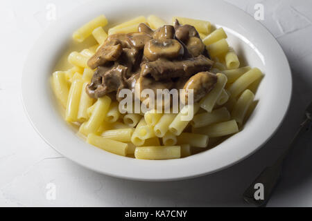 Beef Stroganoff on pasta close up - Russian food background Stock Photo