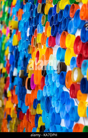 Background of bright colored plastic plugs side view vertical Stock Photo