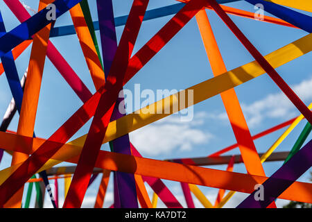 Framework of multi-colored ribbons against the blue sky close-up horizontal Stock Photo