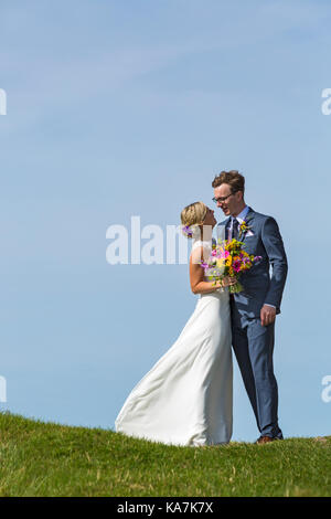 Bride and groom just married at Church of St. Michael de Rupe, St. Michael of the Rock, at Brentor, Dartmoor National Park, Devon, UK in September Stock Photo