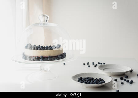 cheesecake with blueberries on glass stand