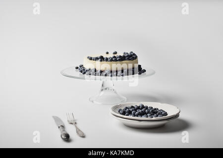 cheesecake with blueberries on glass stand