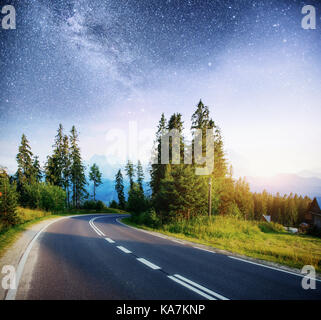 Asphalt road under a starry night sky and the Milky Way Stock Photo - Alamy