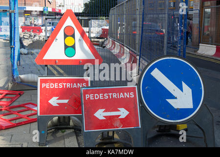 signs cluttered around roadworks in kingston upon thames, surrey, england, including misleading pedestrians route signs Stock Photo