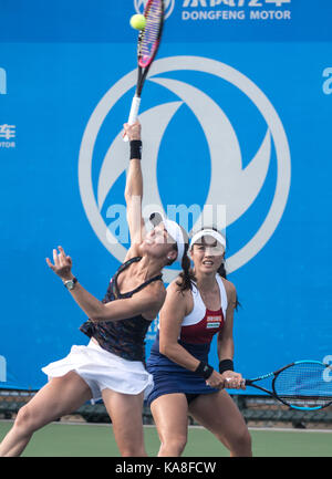 Wuhan, China. 26th Sep, 2017. Chan Yung-Jan (R) of Chinese Taipei and Martina Hingis of Switzerland return the ball during the doubles second round match against Raquel Atawo of the United States and Darija Jurak of Croatia at 2017 WTA Wuhan Open in Wuhan, capital of central China's Hubei Province, on Sept. 26, 2017. Chan and Hingis won 2-0. Credit: Xinhua/Alamy Live News Stock Photo