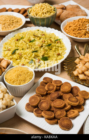 stock photo of  Diwali food or Diwali snacks or Diwali sweets like anarsa, bakarvadi, chakli, sev, bhujiya, shankar pale and chivda or chiwada, karanj Stock Photo
