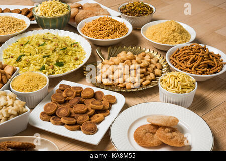 stock photo of  Diwali food or Diwali snacks or Diwali sweets like anarsa, bakarvadi, chakli, sev, bhujiya, shankar pale and chivda or chiwada, karanj Stock Photo