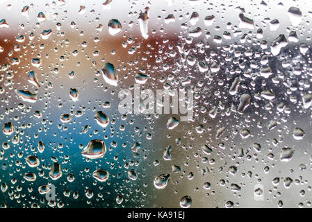 Texture of water droplets on glass on a colored background Stock Photo