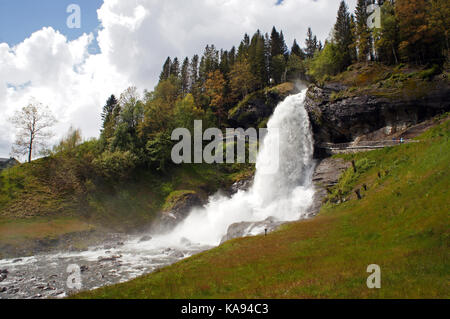 Steinsdalsfossen waterfall in the river of Steine, scenic landscape with cascade surounded by mountains and rocks Stock Photo