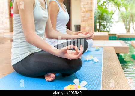 Young couple practicing yoga in the lotus position outdoor Stock Photo