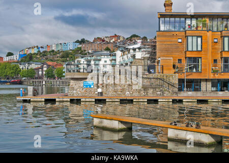 BRISTOL ENGLAND THE CITY CENTRE AND HARBOUR ON THE RIVER AVON AT HOTWELLS WITH COLOURED HOUSES ON THE SKYLINE AND WOOD FRONTED APARTMENTS Stock Photo