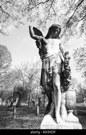 RAHWAY, NEW JERSEY - April 28, 2017: Details of an angel statue atop a grave at Rahway Cemetery Stock Photo