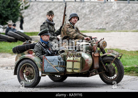 Gryfino, Poland, 23 september 2017: Historical reconstruction of the battle at Arnhem, German soldiers riding on a motorcycle. Stock Photo