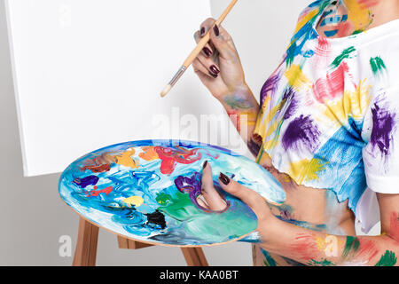 female artist holding palette with paints for drawing Stock Photo - Alamy