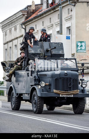 Gryfino, Poland, 23 september 2017: Historical reconstruction of the battle at Arnhem, German soldiers riding a large military car. Stock Photo