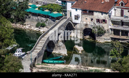 Montenegro - The ancient triple arched bridge in the old town of Rijeka Crnojevica spanning the river of a same name Stock Photo
