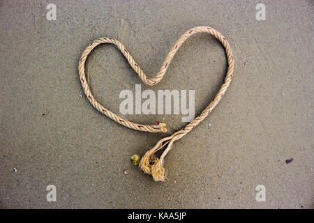 Rope heart-shaped on the beach. Stock Photo