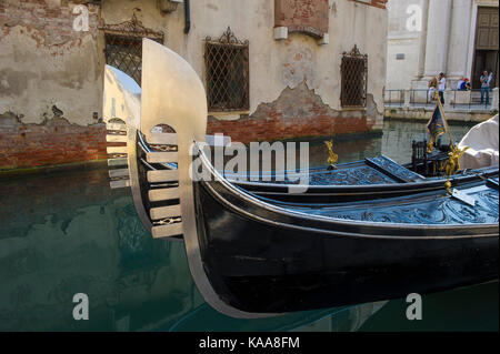 Venice canals and Gondoliers steering their Gondolas Stock Photo