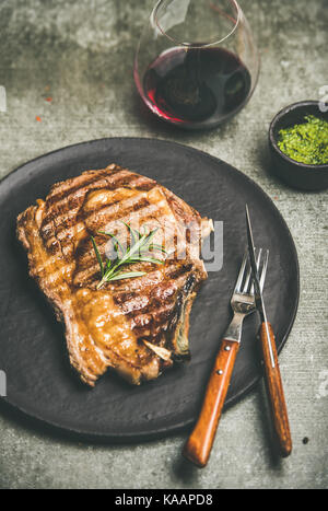 Grilled hot rib-eye beef steak with red wine Stock Photo