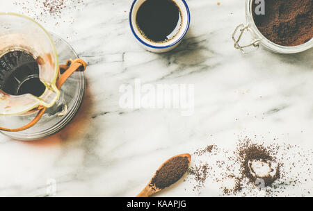 Black filtered coffee in Chemex and white cup, flat-lay Stock Photo
