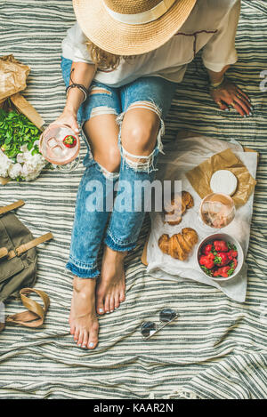 French style outdoor picnic setting with young woman in hat Stock Photo