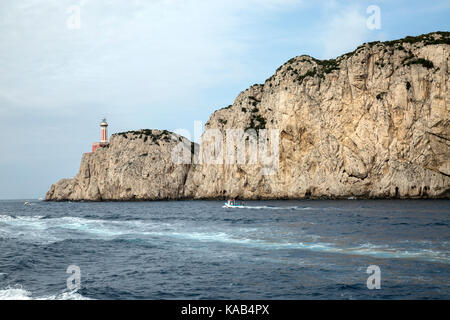 View of Capri, with punta carena lighthouse, on limestone cliff, from ocean side