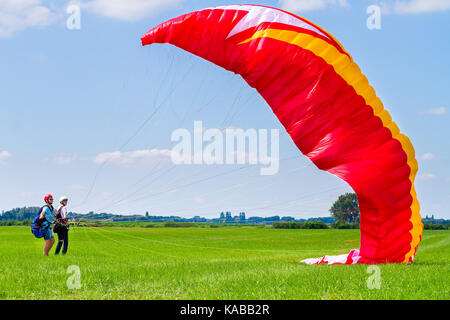 Paragliding instructor with boy preparing mattress flyer Stock Photo