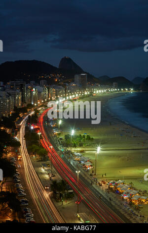 Traffic along Avenida Atlantica and Copacabana Beach at dusk, Rio de Janeiro, Brazil, South America Stock Photo
