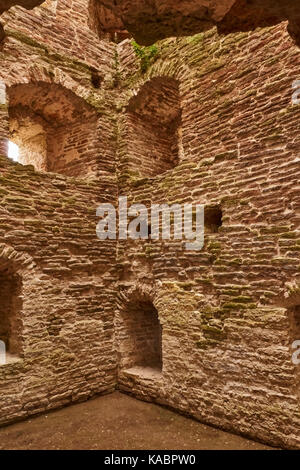 From the floor of the ancient square watchtower are seen the walls in which the windows are loopholes. The walls are made of limestone. Russia, Pskov Stock Photo