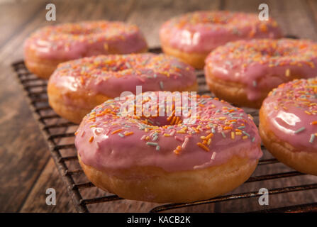 Pink Donuts on a wire Cooling Rack Stock Photo