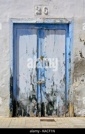 Photo of a weathered blue wooden door Stock Photo