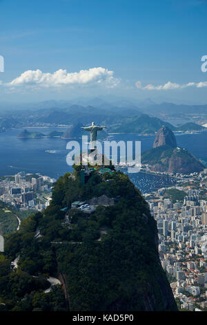 Christ the Redeemer statue atop Corcovado, and Sugarloaf Mountain, Rio de Janeiro, Brazil, South America - aerial