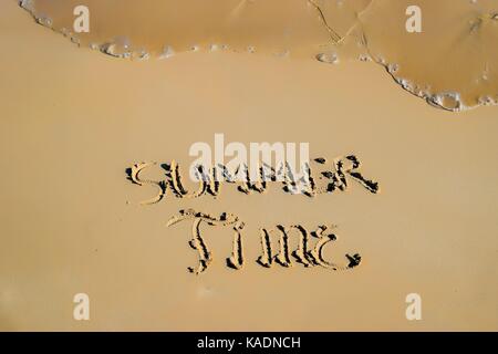 Inscription 'Summer Time' in the sand on a tropical island Stock Photo