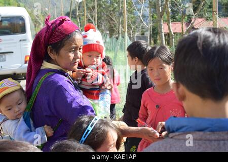 Ha Giang, Vietnam - November 08, 2018: Unidentified group of children wearing Hmong traditional new year clothe, waiting for their dancing perform in  Stock Photo