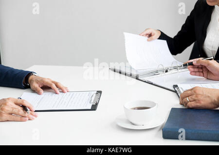 Businessman conducting an interview with businessman in an office. Stock Photo