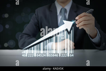 Businessman draw increasing graph with barcode, business growth Stock Photo