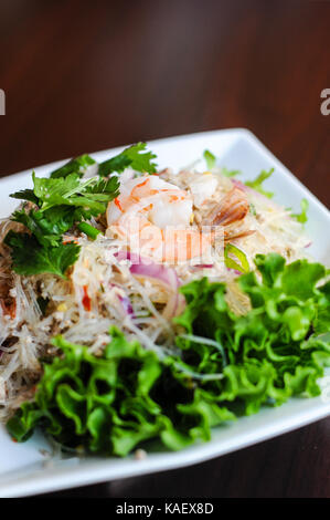 Yum Woonsen Glass Noodle Salad, Glass noodles salad served on a bed of lettuce with chicken and shrimp. Stock Photo