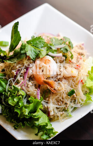 Yum Woonsen Glass Noodle Salad, Glass noodles salad served on a bed of lettuce with chicken and shrimp. Stock Photo