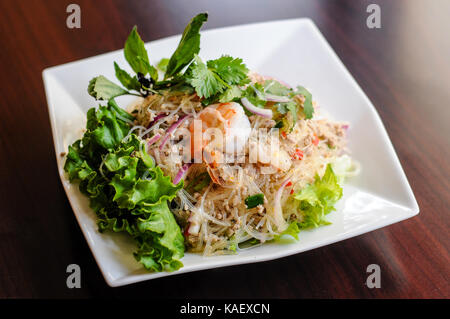 Yum Woonsen Glass Noodle Salad, Glass noodles salad served on a bed of lettuce with chicken and shrimp. Stock Photo