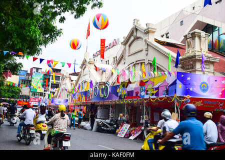 Vehicles traveling on a street beside Dong Xuan market in Hanoi capital. Dong Xuan market in mid autumn festival Stock Photo