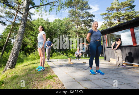 Friends Playing With Blocks While Standing Opposite To Each Othe Stock Photo