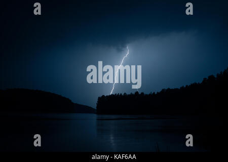 Lightning storm on a lake Stock Photo